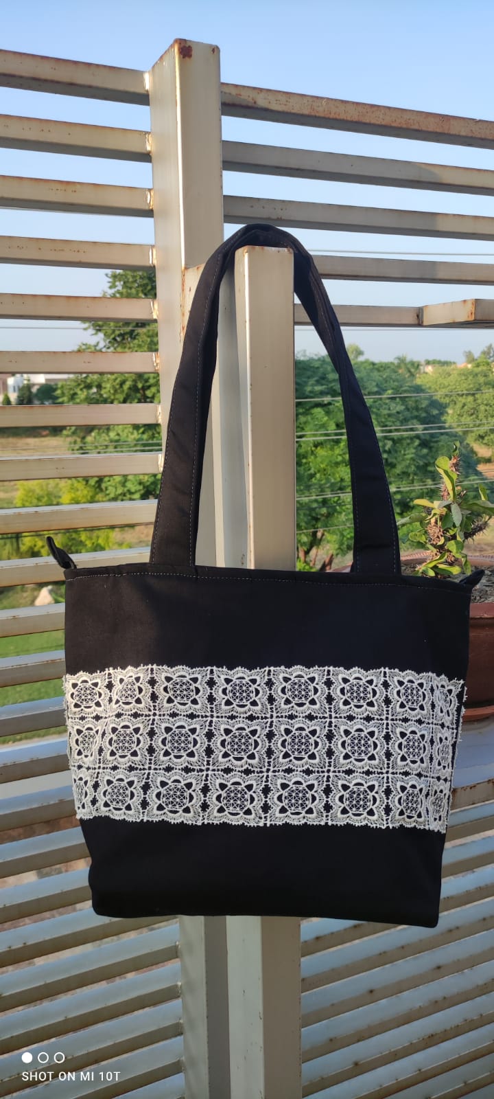 Elegant Black Canvas Tote Bag with Intricate Lace Detailing