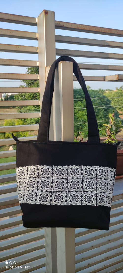 Elegant Black Canvas Tote Bag with Intricate Lace Detailing