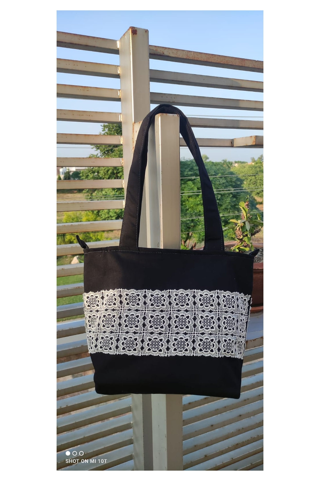 Elegant Black Canvas Tote Bag with Intricate Lace Detailing